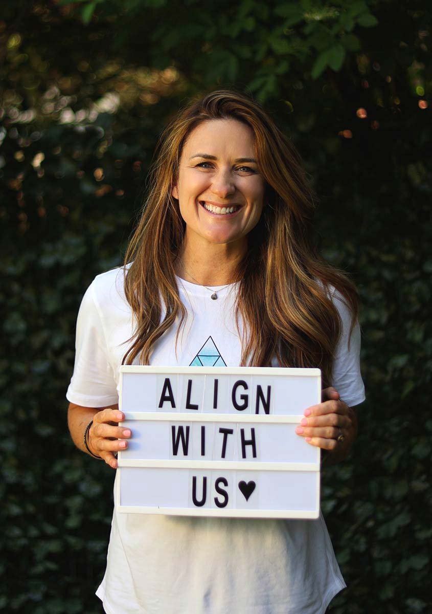 Soul Truth Collective founder holding an Align With Us sign